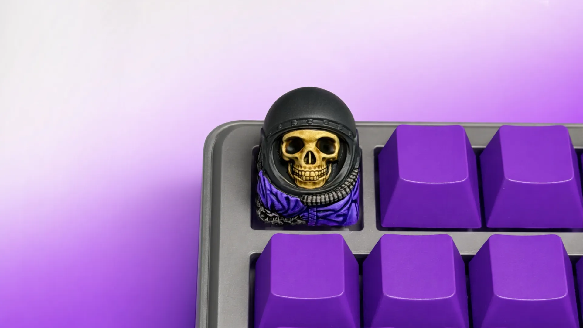 XIIX Astronaut artisan keycap on a purple mechanical keyboard, front view