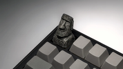 XIIX Moai Ancient Stone artisan keycap on a grey mechanical keyboard, angled view