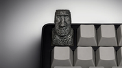 XIIX Moai Ancient Stone artisan keycap on a grey mechanical keyboard, front view