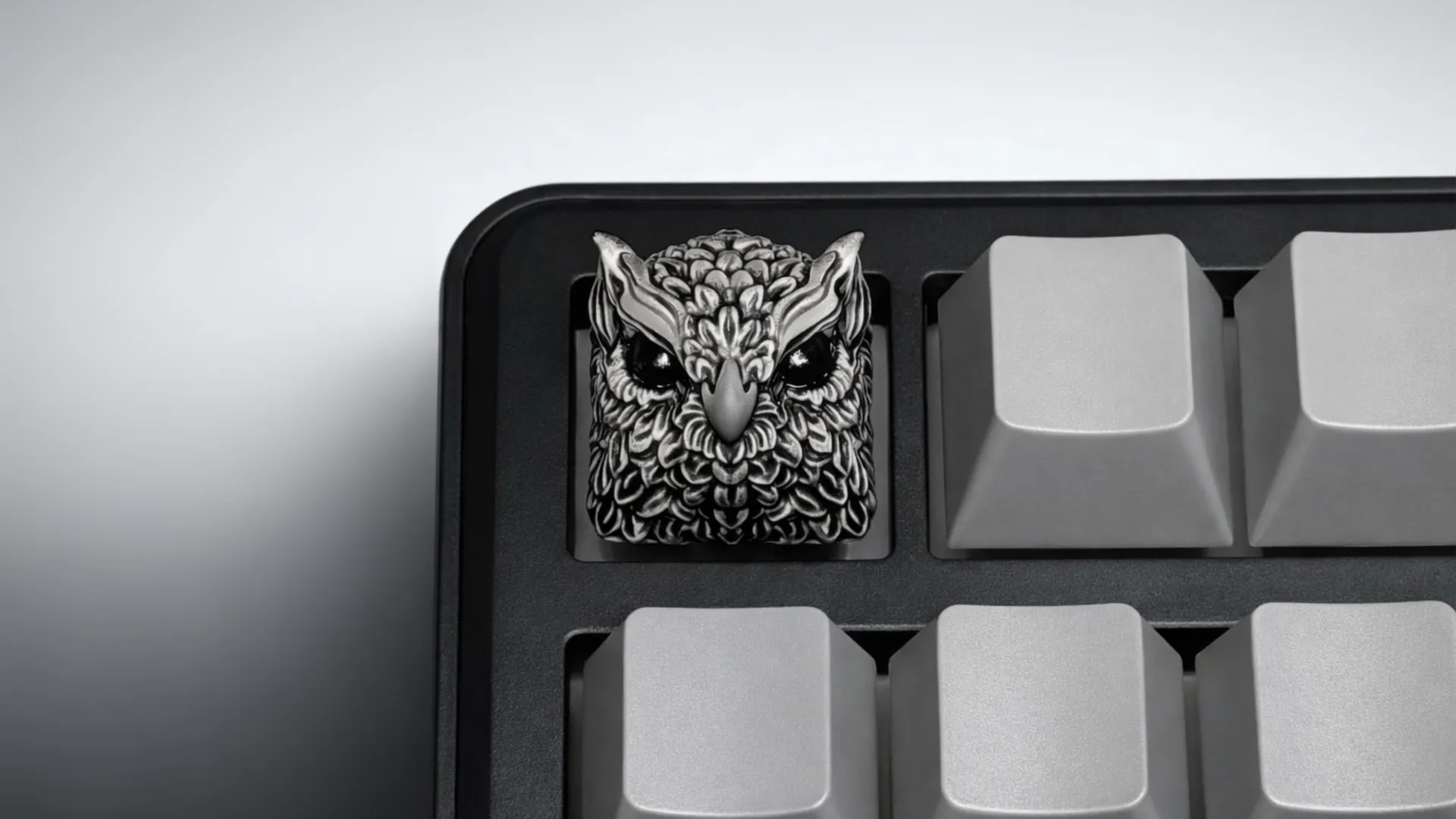 XIIX Owl Gloom artisan keycap on a black and grey mechanical keyboard, front view