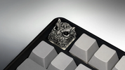 XIIX Owl Gloom artisan keycap on a black and grey mechanical keyboard, angled view