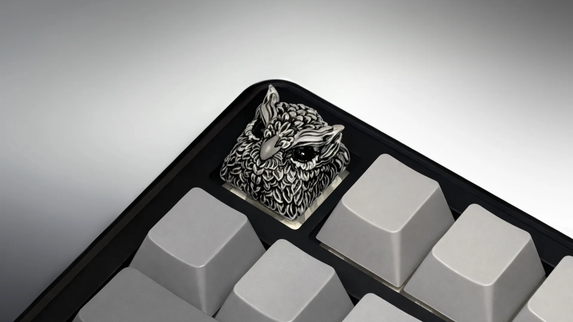 XIIX Owl Gloom artisan keycap on a black and grey mechanical keyboard, angled view