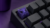 XIIX Owl Indigo artisan keycap on a dark mechanical keyboard, angled view