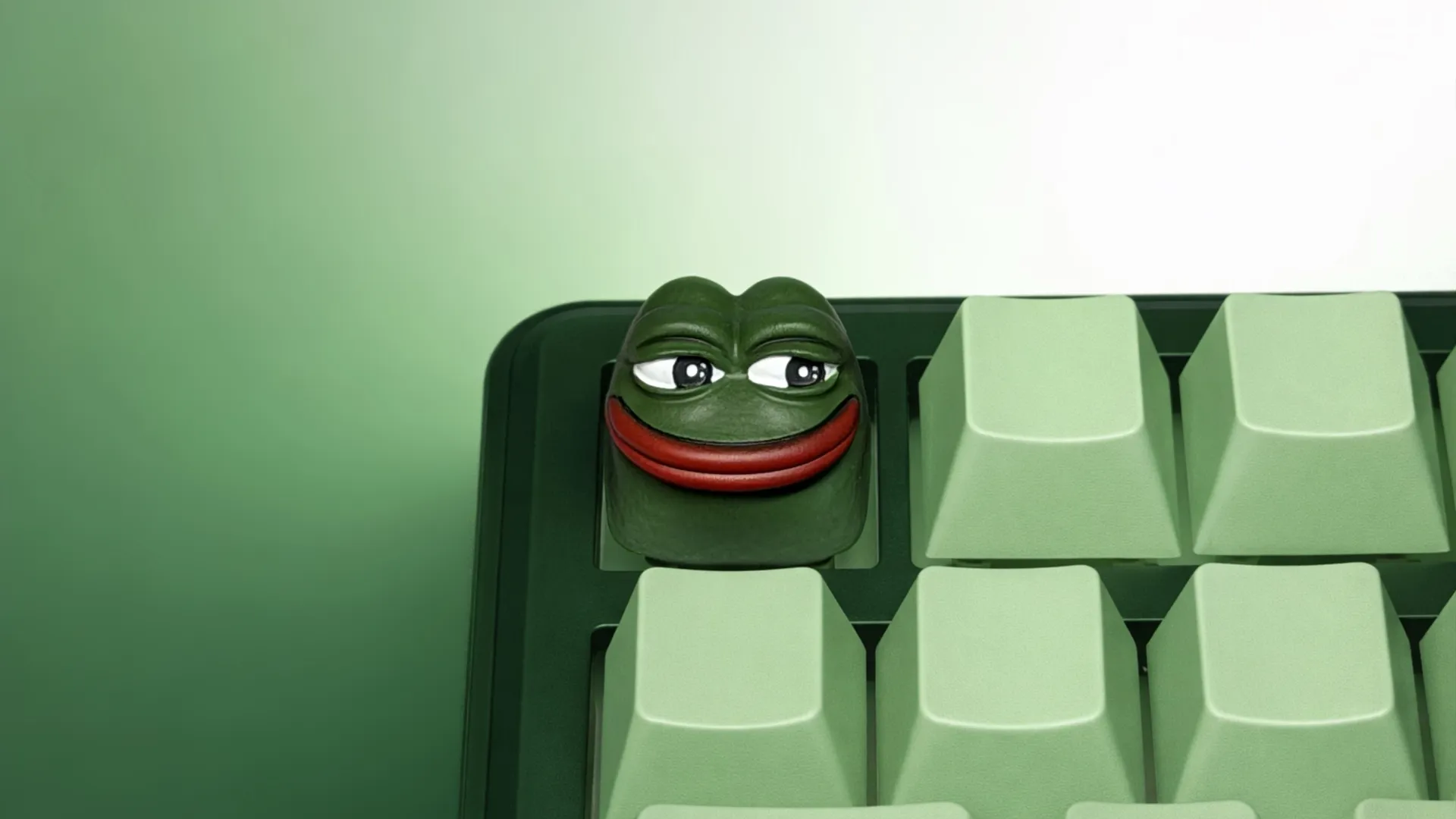 XIIX Pepe the Frog artisan keycap on a green mechanical keyboard, front view
