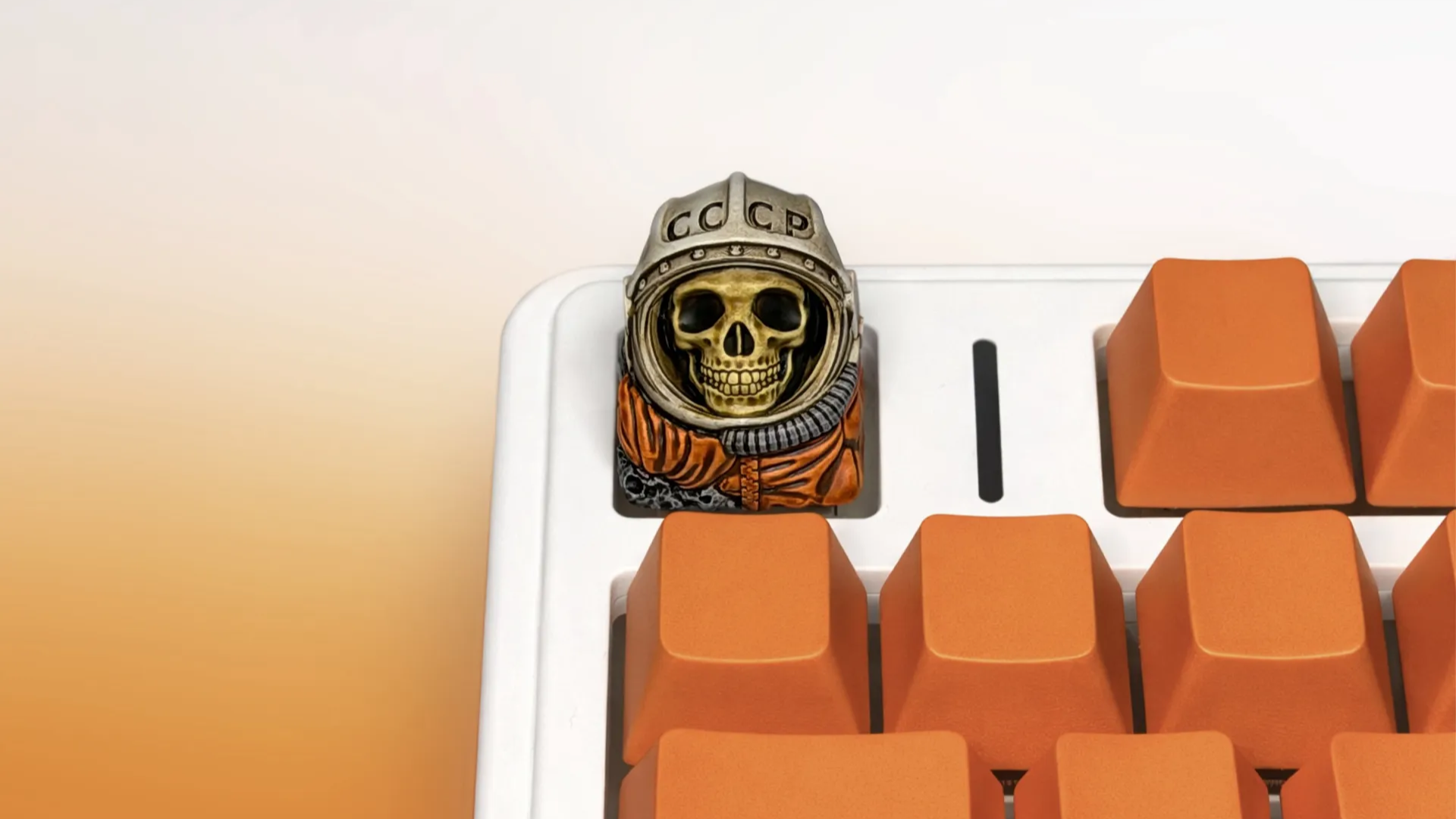 XIIX USSR Remnant cosmonaut artisan keycap on an orange mechanical keyboard, front view