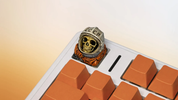 XIIX USSR Remnant cosmonaut artisan keycap on an orange mechanical keyboard, angled view