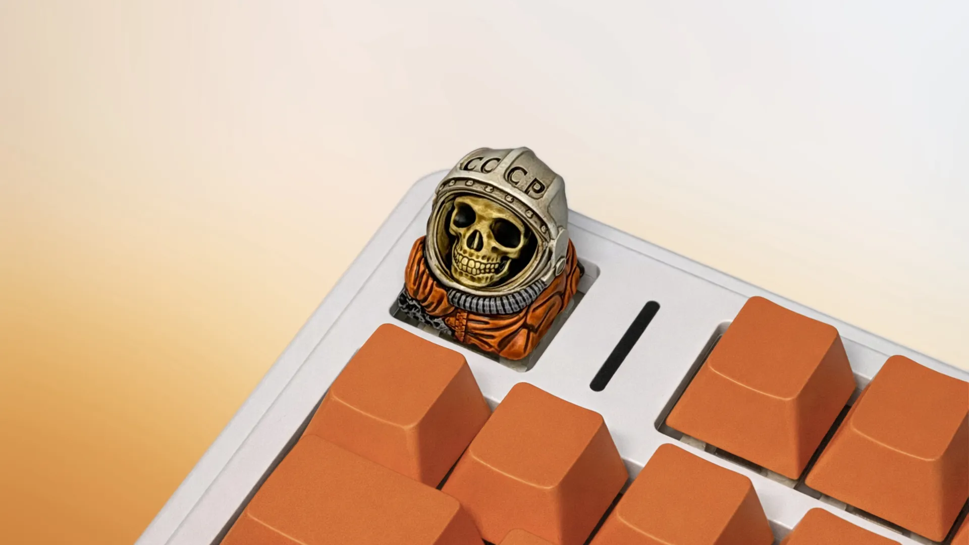 XIIX USSR Remnant cosmonaut artisan keycap on an orange mechanical keyboard, angled view